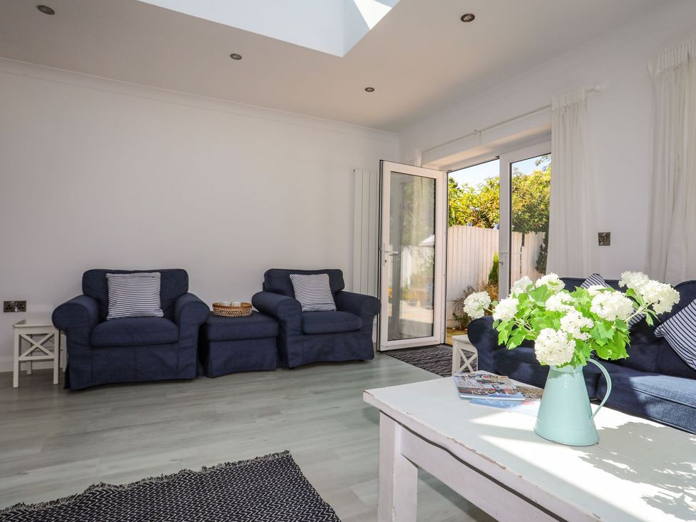 A living room with two sofas and a coffee table at 15 Llwyn Gwalch Estate in Pwllheli