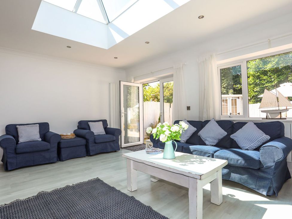 A living room with sofas and a table at 15 Llwyn Gwalch Estate Pwllheli
