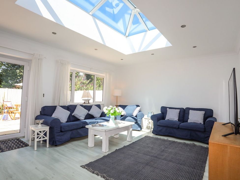 A living room with sofas and a coffee table at 15 Llwyn Gwalch Estate Pwllheli