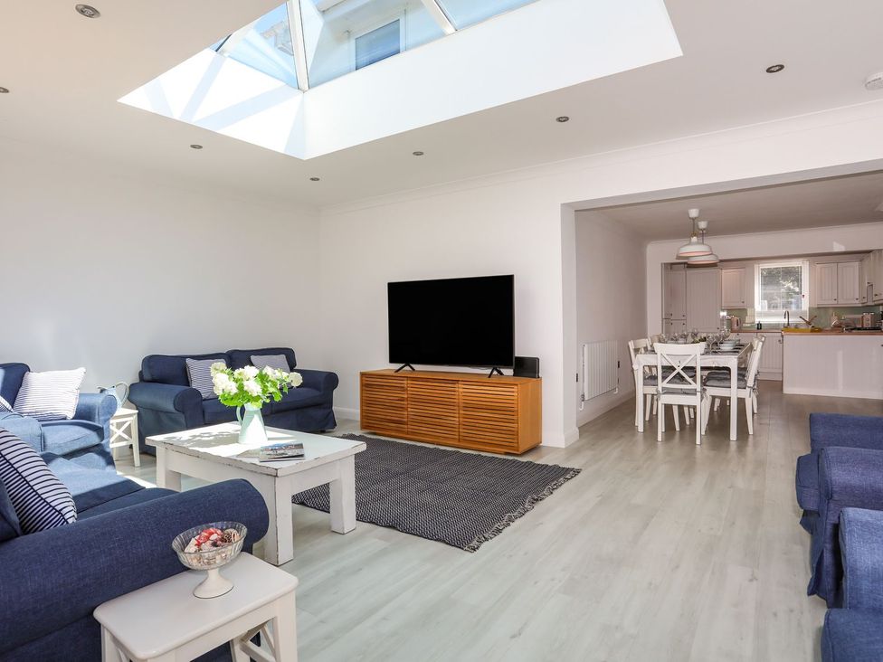 A living room with a television and a dining area at 15 Llwyn Gwalch Estate Pwllheli