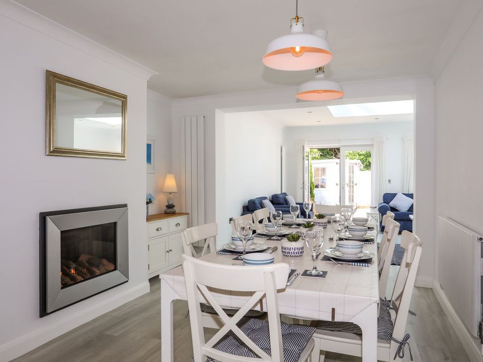 A dining room with a table set for a meal at 15 Llwyn Gwalch Estate Pwllheli