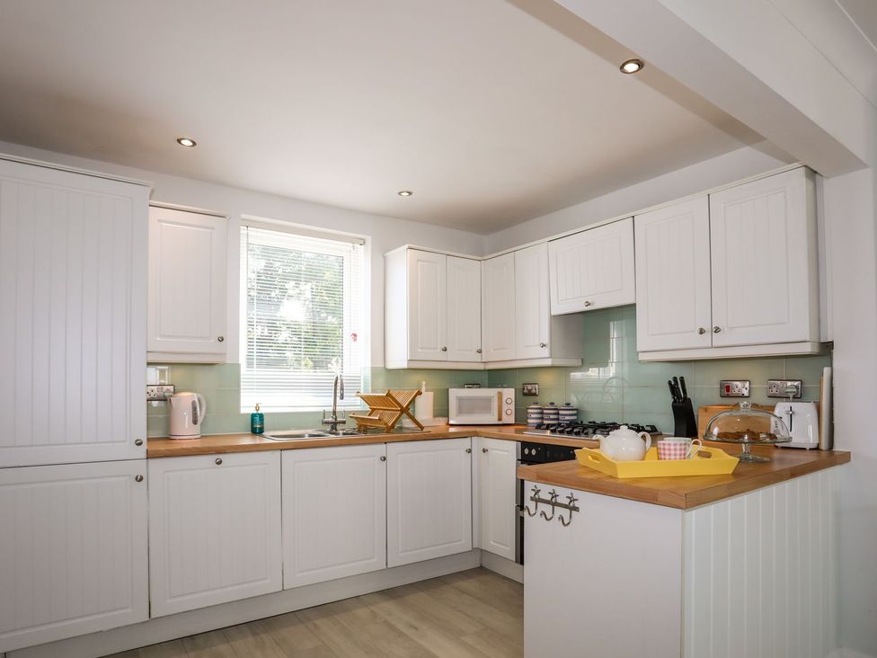 A kitchen with cabinets and a sink at 15 Llwyn Gwalch Estate in Pwllheli