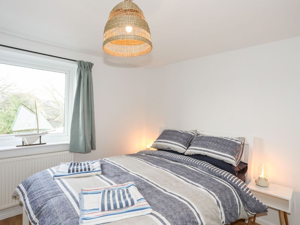 A bedroom with a bed and window at 15 Llwyn Gwalch Estate Pwllheli