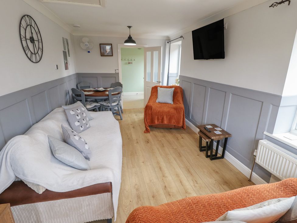A living room with a sofa and dining table at Southfields Annex Little Carlton near Louth