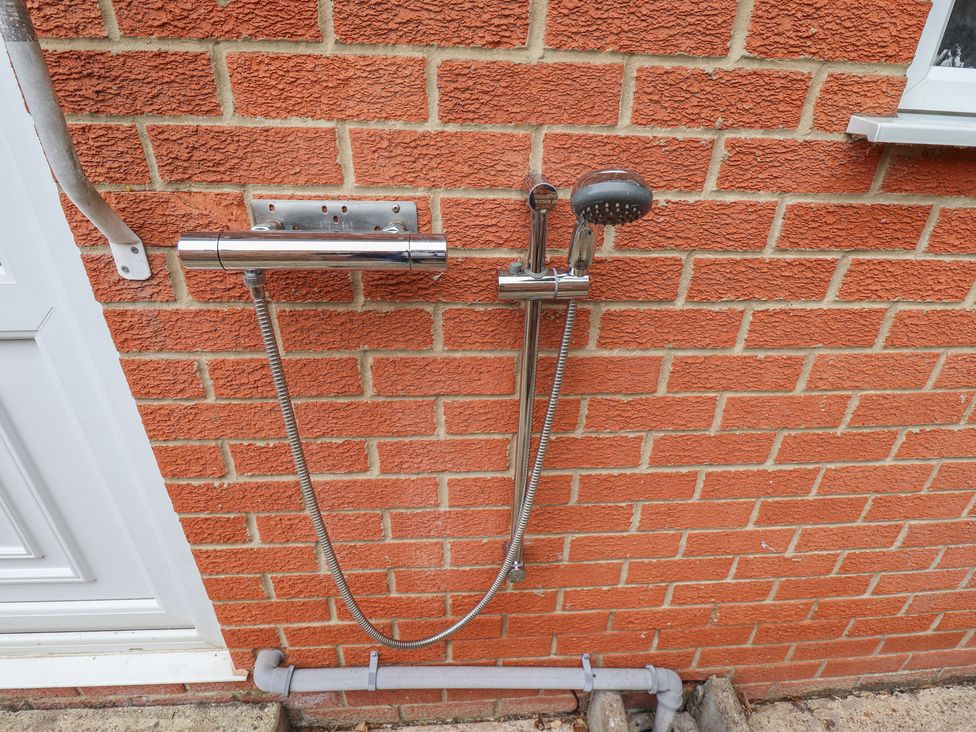 An outdoor shower system attached to a brick wall at Southfields Annex Little Carlton near Louth