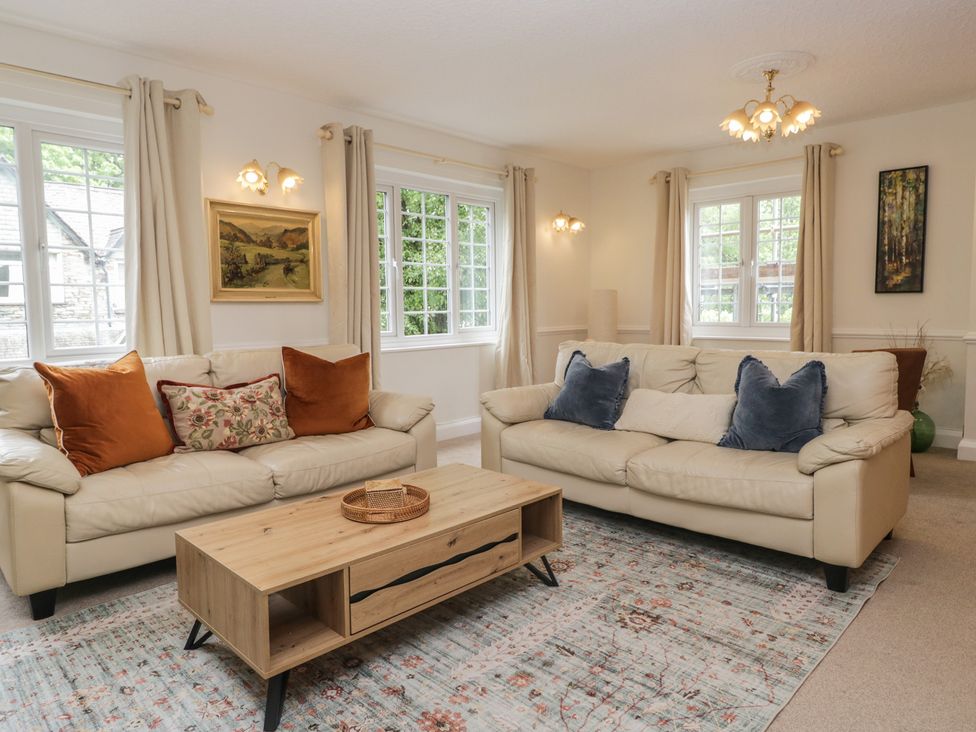 A living room with sofas and a coffee table at Cumbria house