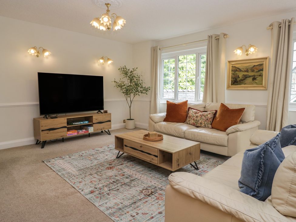 A living room with a television and coffee table at Cumbria house