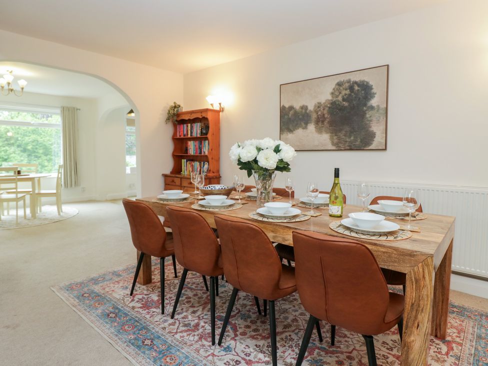 A dining area with a wooden table and chairs at Cumbria house