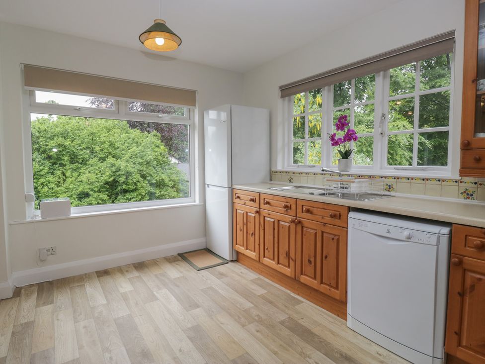 A kitchen with fridge, sink and dishwasher at Cumbria house