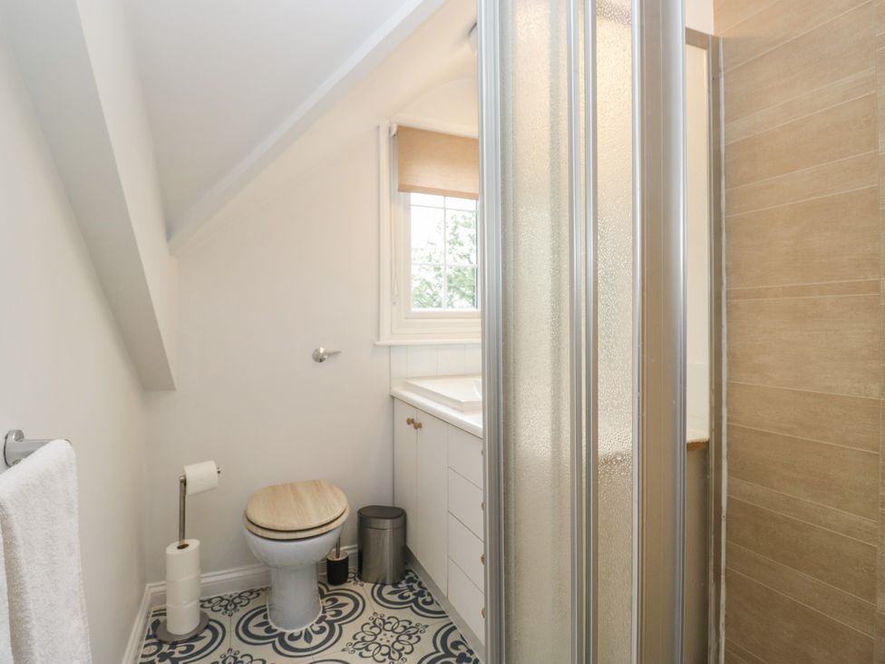 A bathroom with a sink, toilet and shower at Cumbria house
