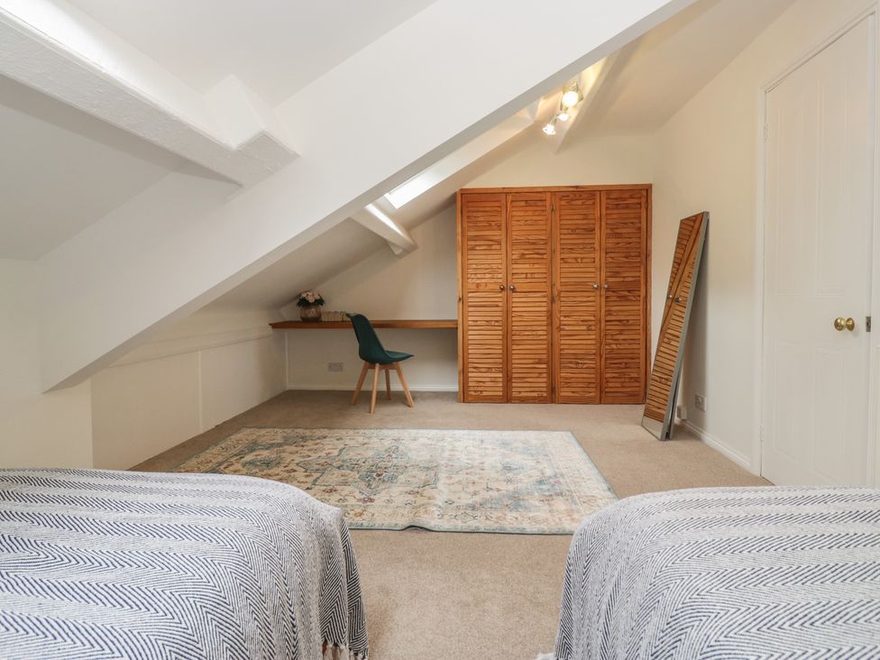 A bedroom with a bed and desk at Cumbria house