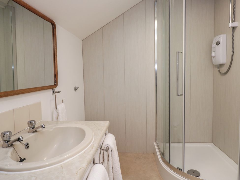 A bathroom with a sink and shower at Cumbria house