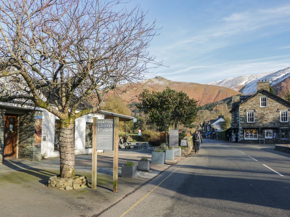 An outdoor view with buildings and mountains at Cumbria house