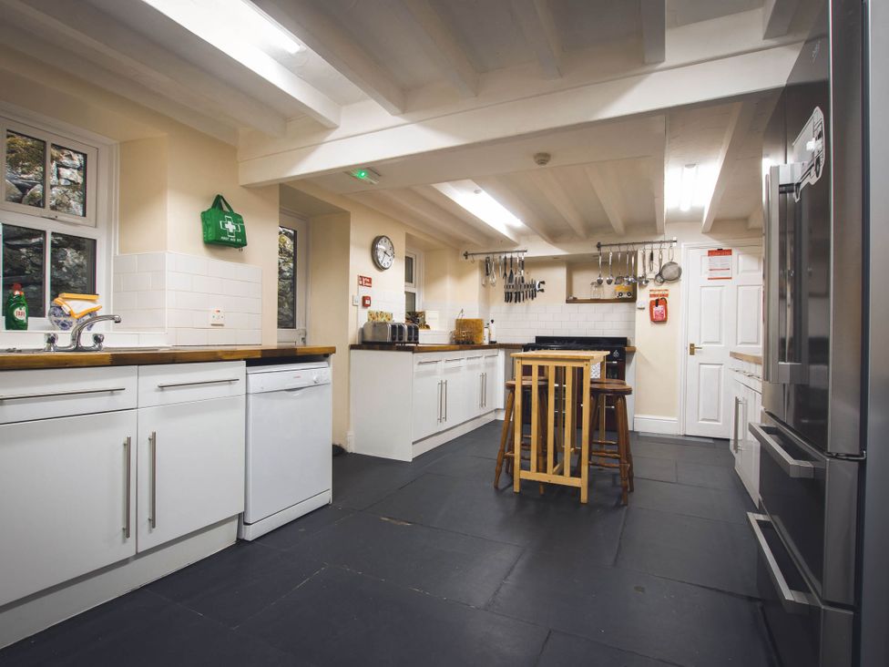 A kitchen with appliances and utensils at Noddfa Country House in Harlech