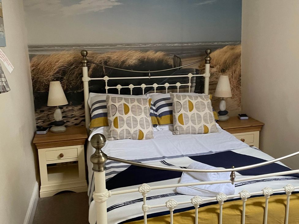 A bedroom with a bed and bedside table at Noddfa Country House in Harlech