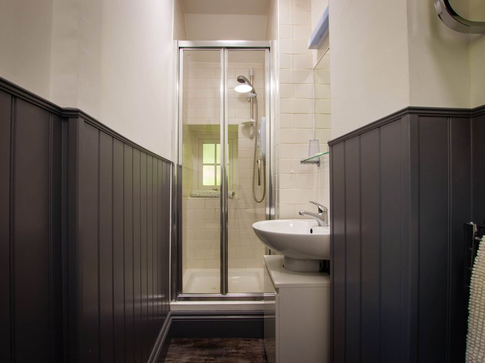 A bathroom with a shower and sink at Noddfa Country House in Harlech