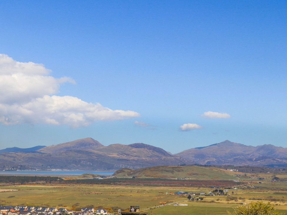 A landscape view of mountains and houses at Noddfa Country House in Harlech