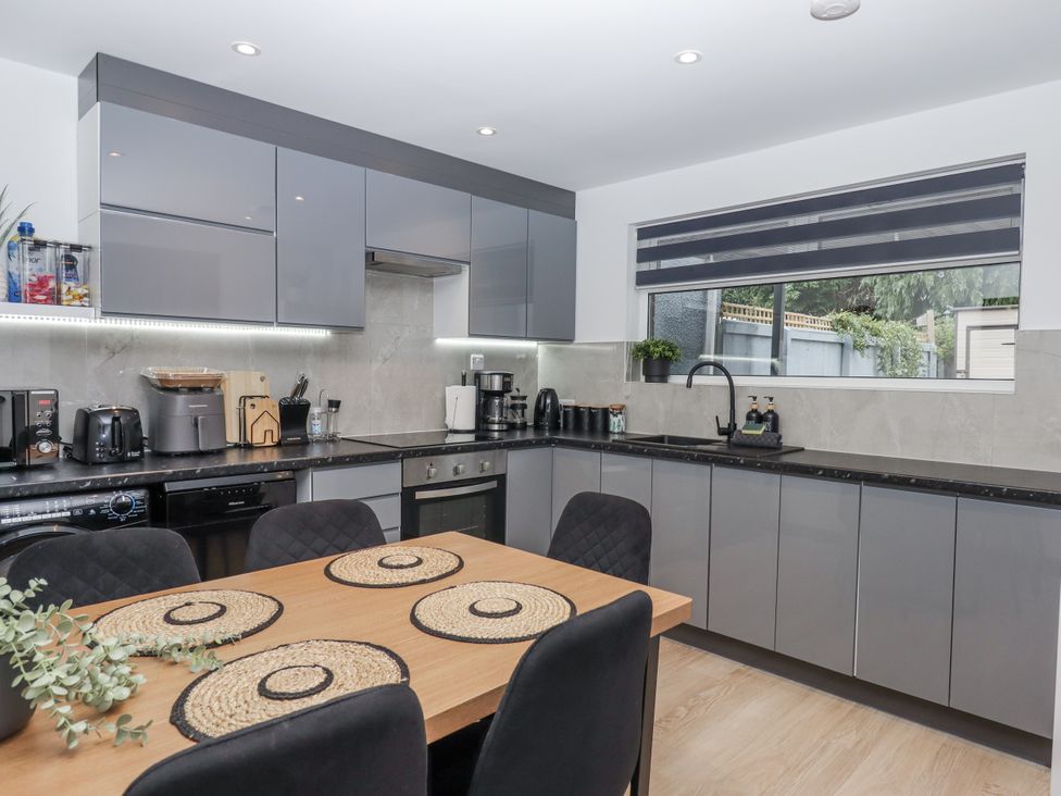 A kitchen with cabinets and appliances at Milana in Tiverton