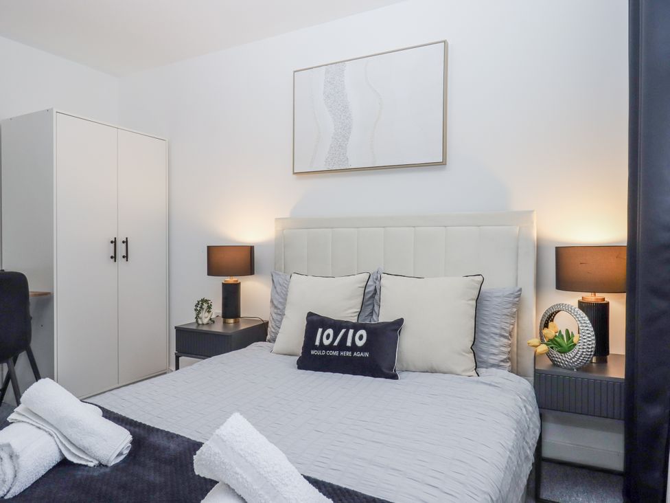 A bedroom with a bed and wardrobe at Milana in Tiverton