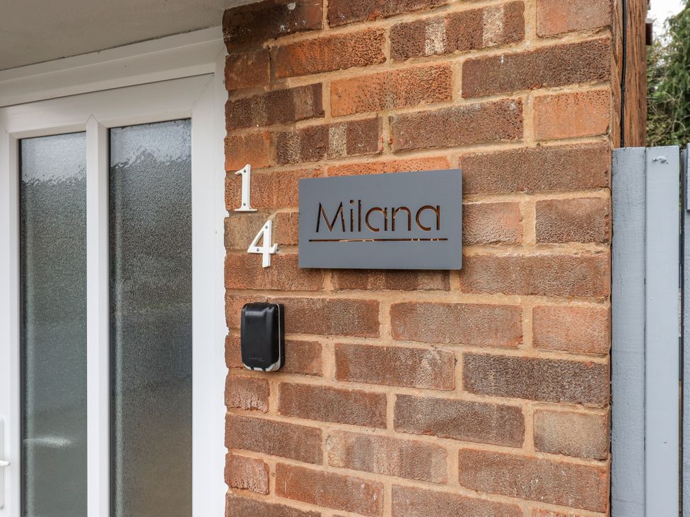 An entrance with a sign and a door at Milana in Tiverton
