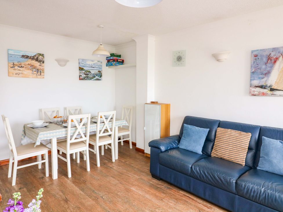 A dining room with a table and chairs at Surf View Hope Cove