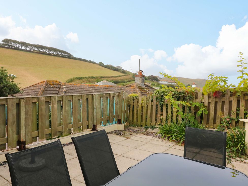 A patio area with a table and chairs at Surf View in Hope Cove