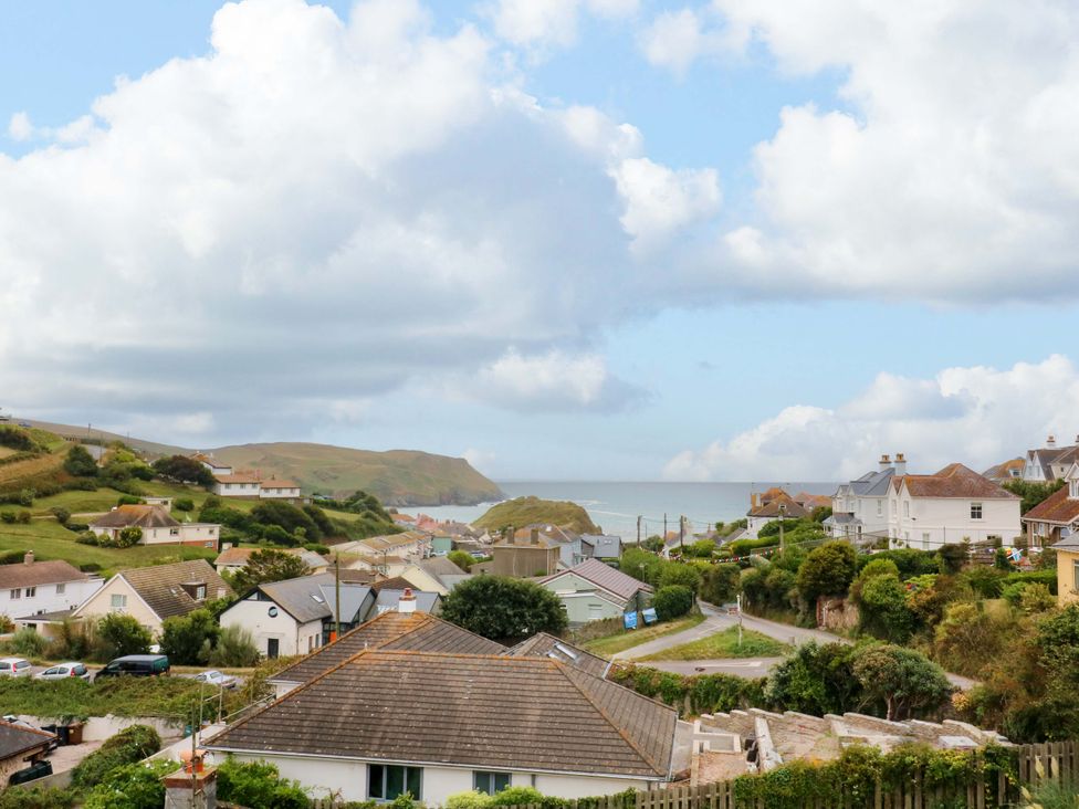 A coastal view with houses and hills at Surf View in Hope Cove