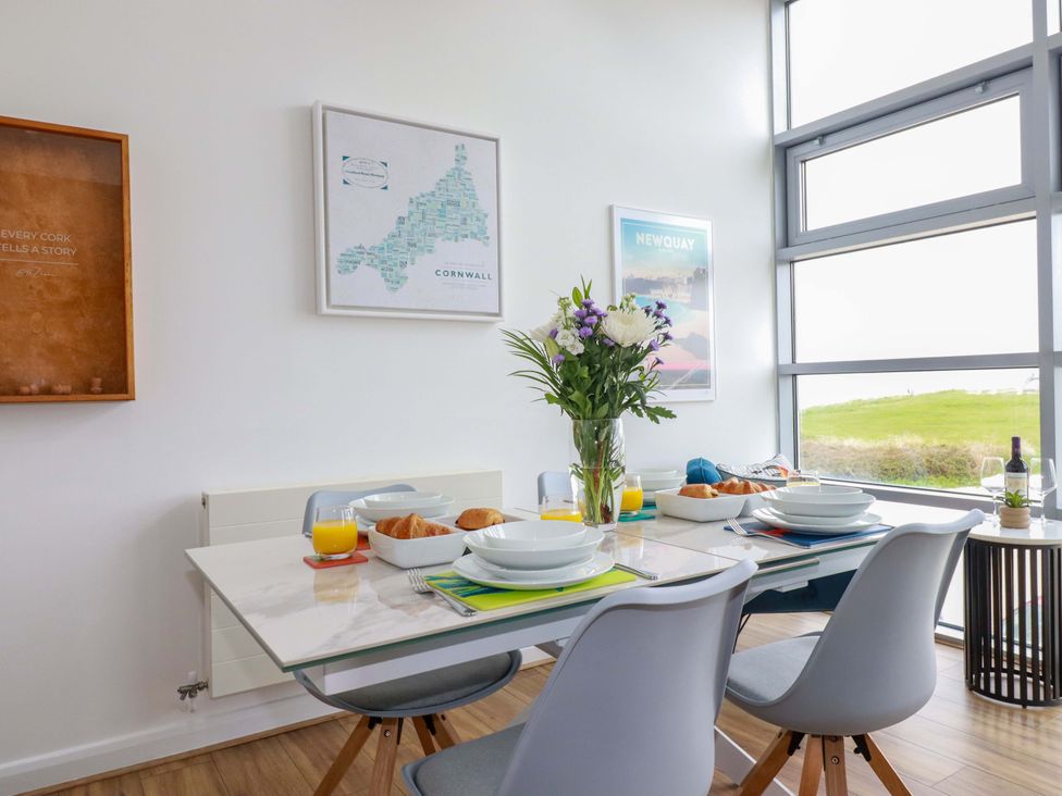 A dining room with a table set for breakfast at Penthouse @46Zinc - Headland View in Newquay