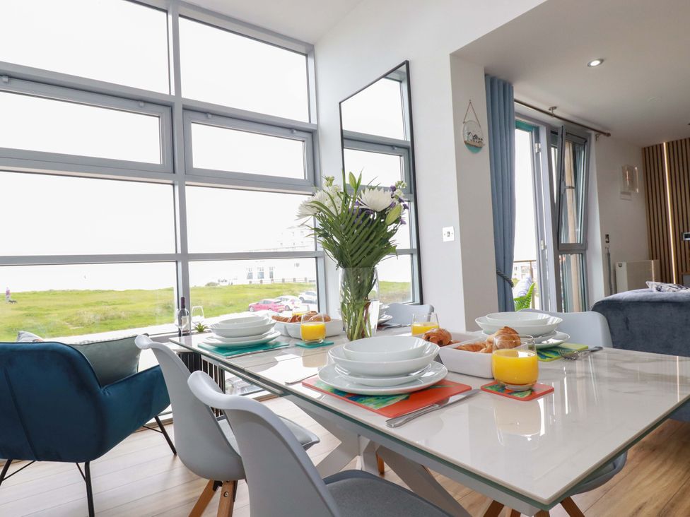 A dining room with a table set for breakfast at Penthouse @46Zinc - Headland View in Newquay