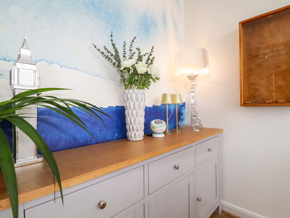 A living room with a sideboard and decorative items at Penthouse @46Zinc - Headland View in Newquay