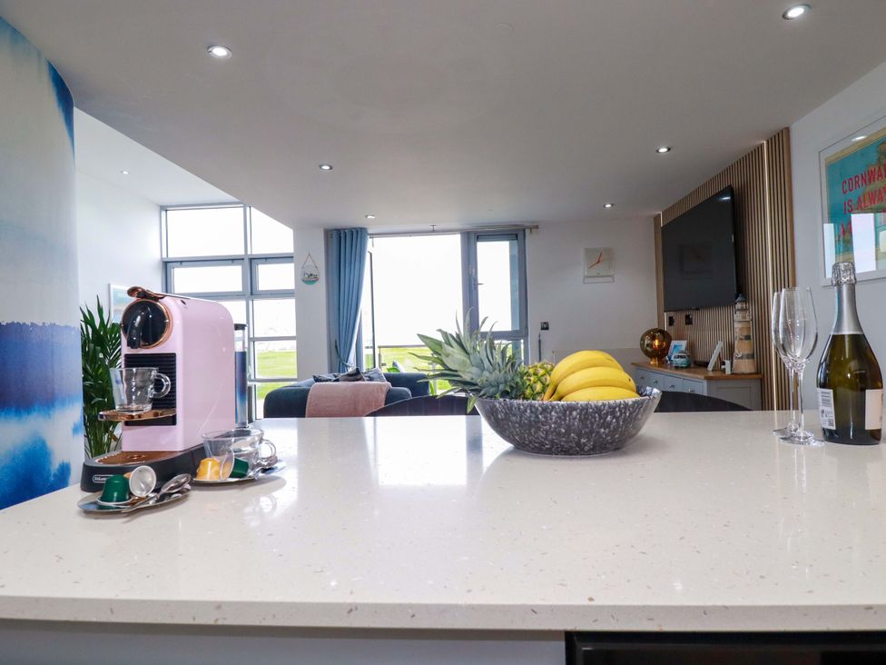 A kitchen with a coffee machine and fruit bowl at Penthouse @46Zinc - Headland View Newquay
