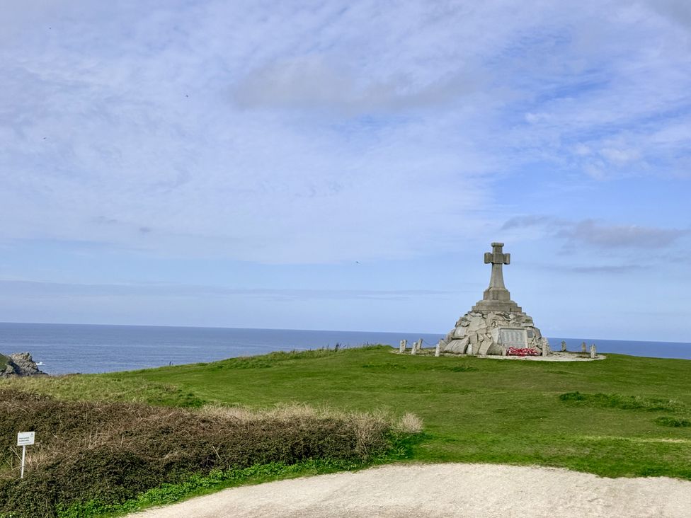 A cross monument on a grassy area overlooking the ocean at Penthouse @46Zinc - Headland View, Newquay