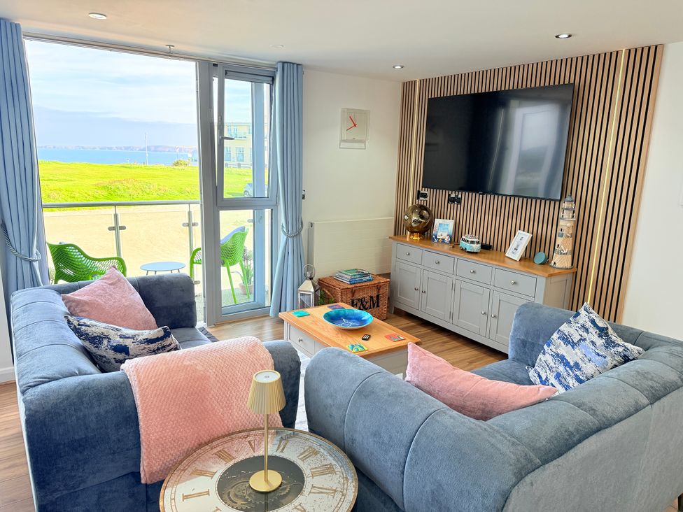 A living room with a sofa and television at Penthouse @46Zinc - Headland View, Newquay