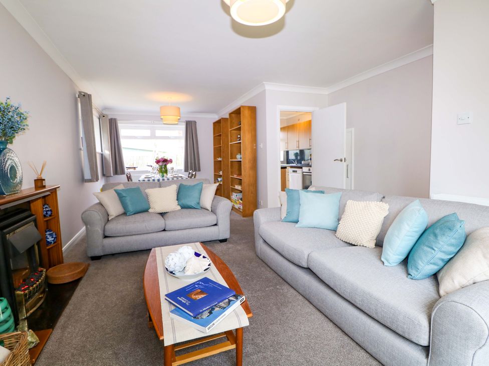 A living room with sofas and a coffee table at 6 Ashton Gardens in Rustington