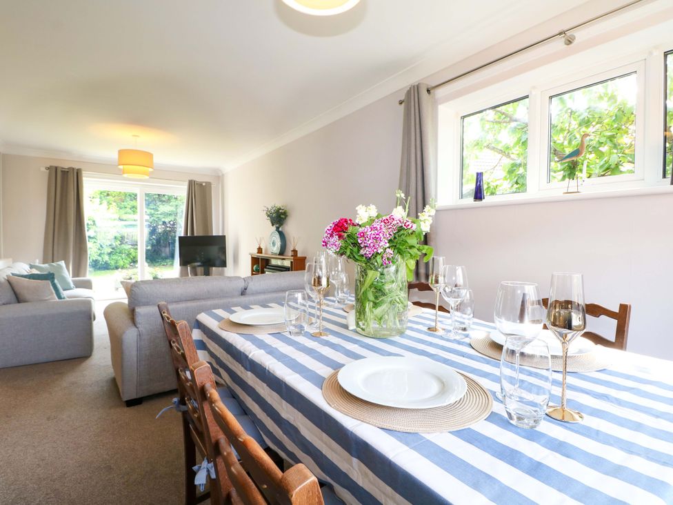 A dining room with a table set for a meal at 6 Ashton Gardens Rustington
