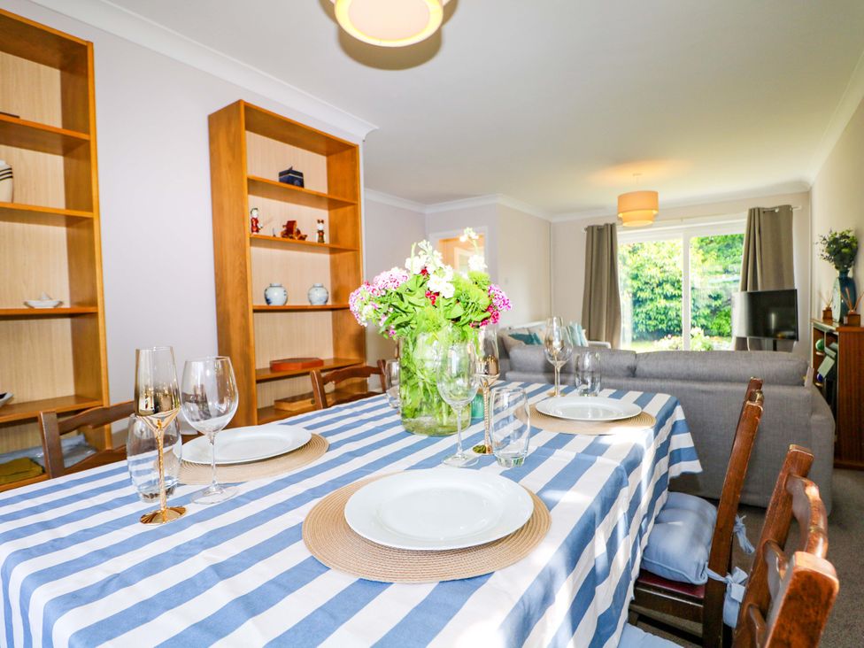 A dining room with a table set for meals at 6 Ashton Gardens Rustington