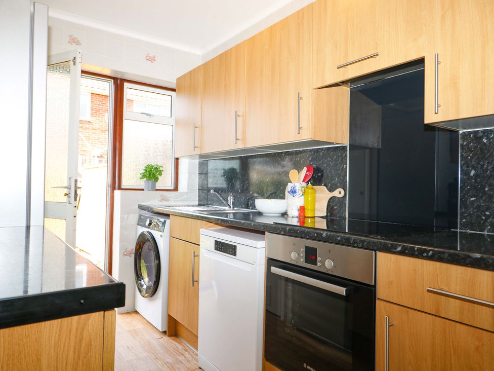 A kitchen with appliances and cabinets at 6 Ashton Gardens, Rustington