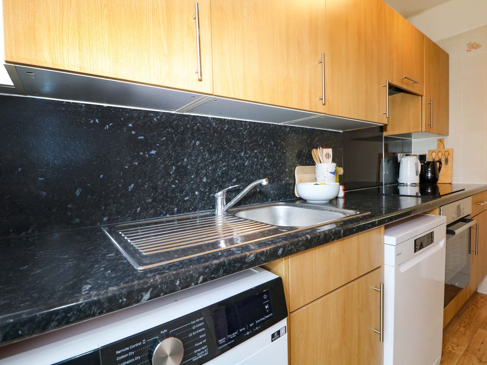 A kitchen with a sink and appliances at 6 Ashton Gardens Rustington