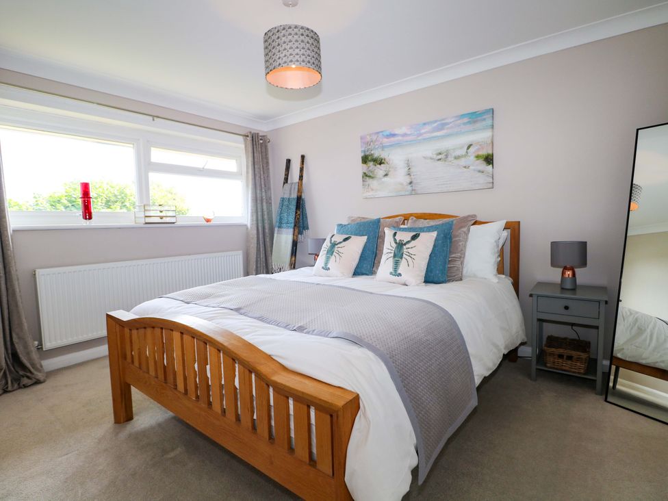 A bedroom with a bed and bedside table at 6 Ashton Gardens Rustington