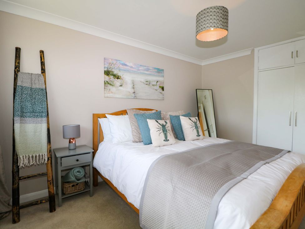 A bedroom with a bed and bedside table at 6 Ashton Gardens Rustington