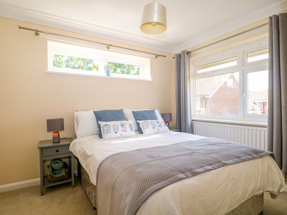 A bedroom with a bed and bedside table at 6 Ashton Gardens Rustington