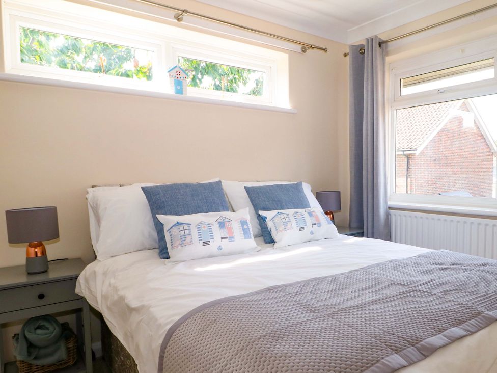 A bedroom with a bed and pillows at 6 Ashton Gardens in Rustington
