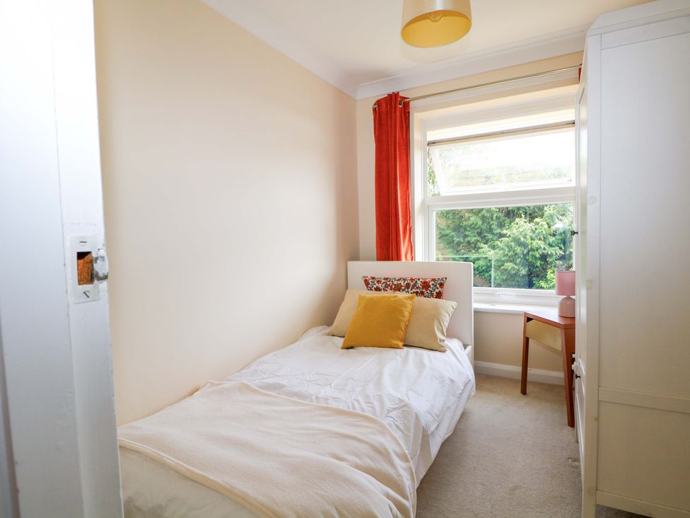 A bedroom with a bed and window at 6 Ashton Gardens in Rustington