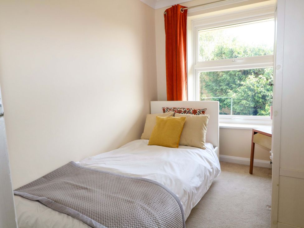 A bedroom with a bed and window at 6 Ashton Gardens in Rustington