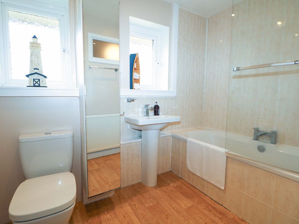 A bathroom with a sink, toilet, and bathtub at 6 Ashton Gardens Rustington