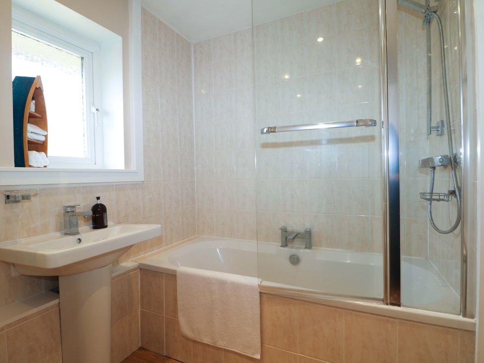 A bathroom with sink and bathtub at 6 Ashton Gardens, Rustington