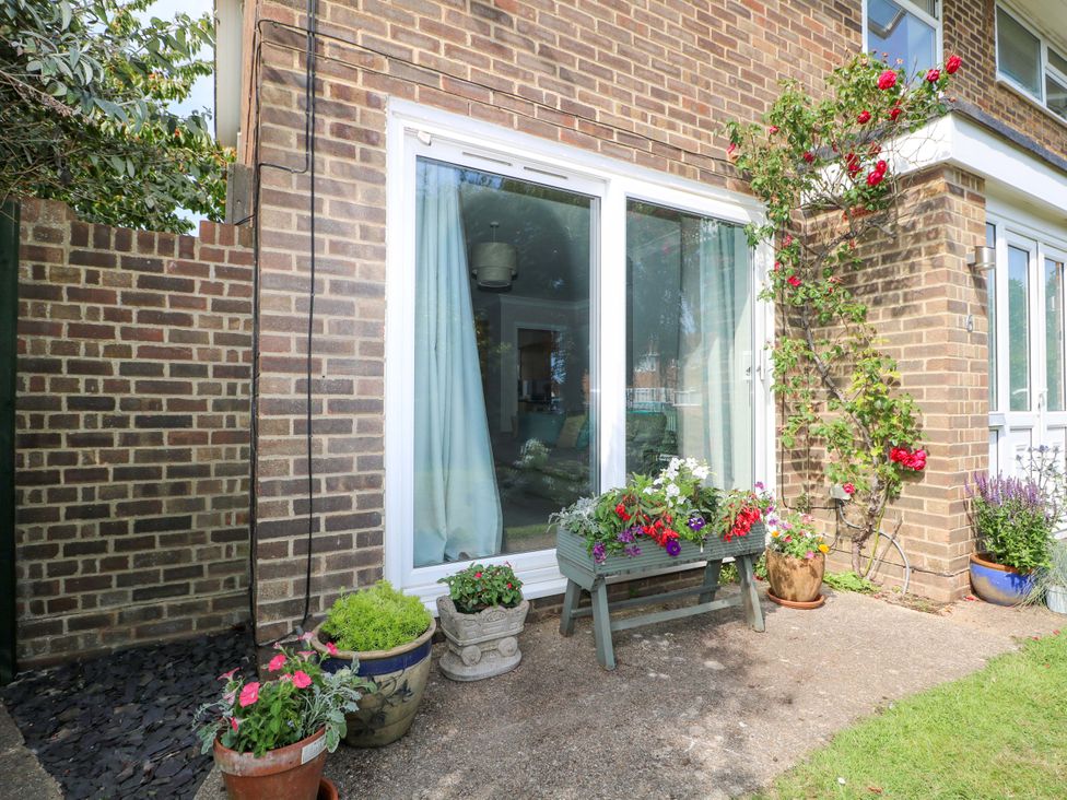 An outdoor area with a window and flower pots at 6 Ashton Gardens, Rustington