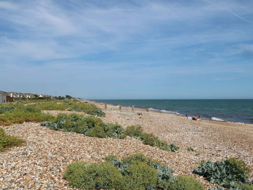 A beach with pebbles and sea at 6 Ashton Gardens Rustington