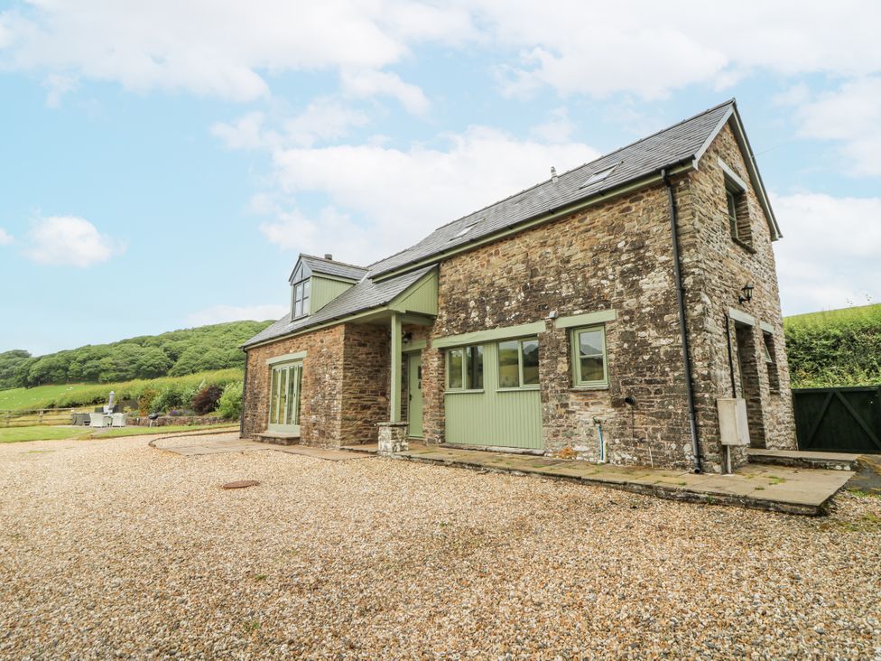 A stone house with a gravel driveway at Waun Yscir Merthyr Cynog near Brecon