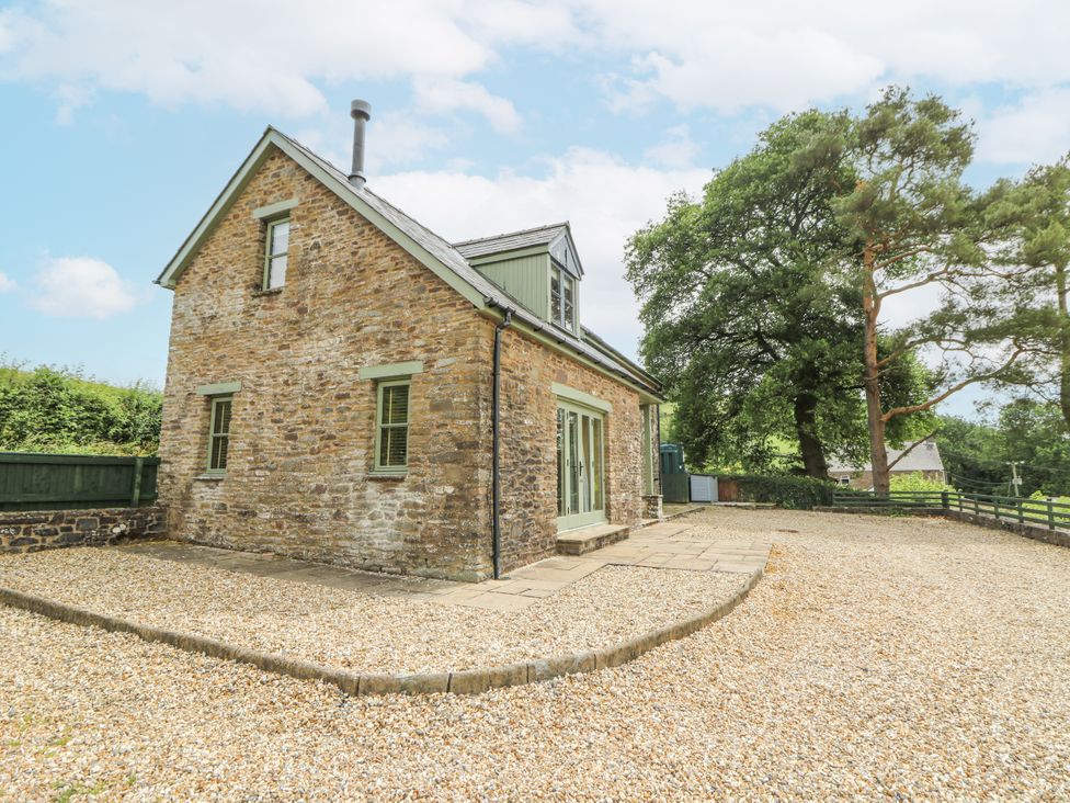 A stone house with a gravel area at Waun Yscir in Merthyr Cynog near Brecon
